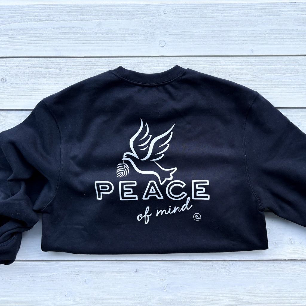 solid black crew heavyweight sweatshirt with white text 'peace of mind' on front left chest. 'peace of mind' bird graphic & text on full back print.