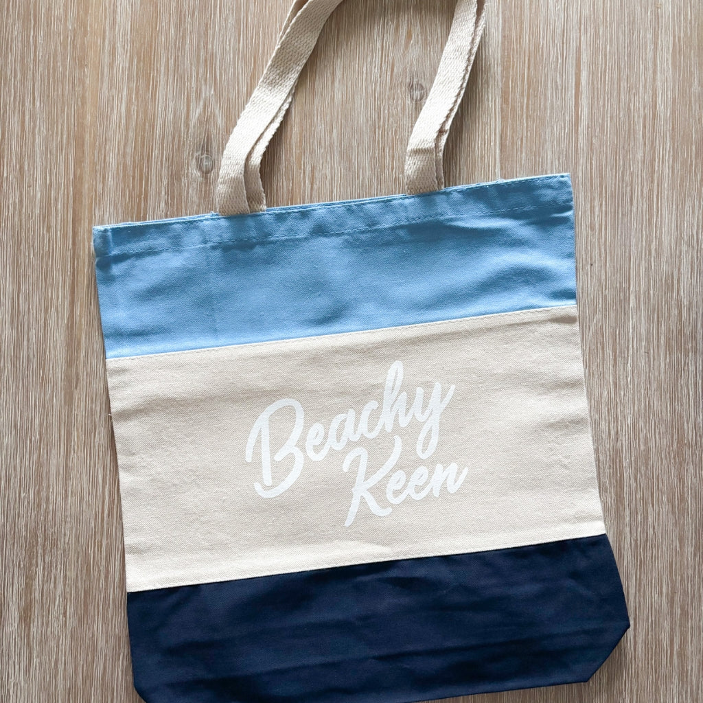 Tote bag with 'Beachy Keen' text on a wooden surface. Beachy Keen tote.  Beach tote.