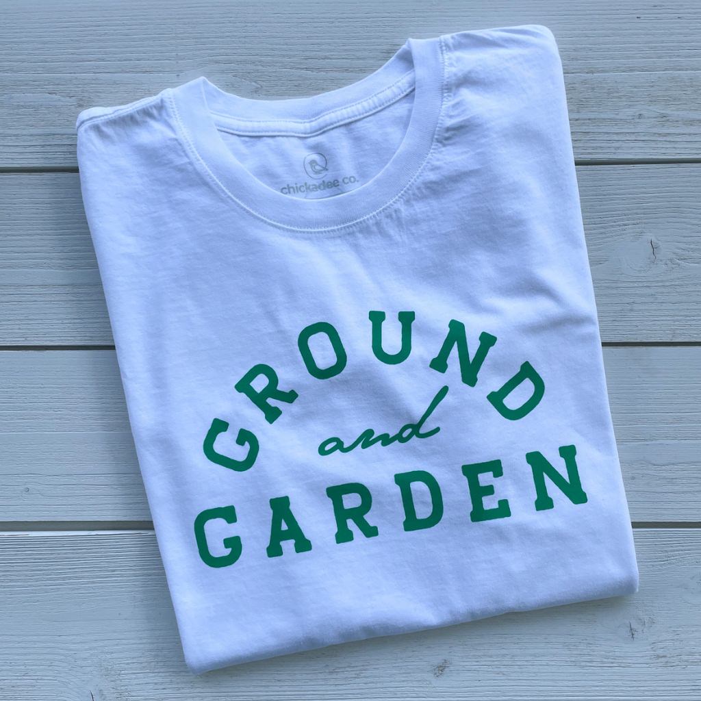 organic cotton apparel.  organic cotton tees.  organic cotton tees for women.  organic cotton tshirts.  organic cotton tshirts for women. 
 white organic cotton tshirt with green text saying ground and garden.  wellness apparel.  garden lover.  grounding tshirt.  gardening tshirt.