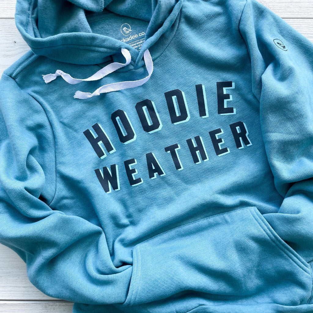 hoodie weather bold printed text on super soft blue hoodie.  text color is two tone black & light blue.  unisex hoodie with saying hoodie weather.
