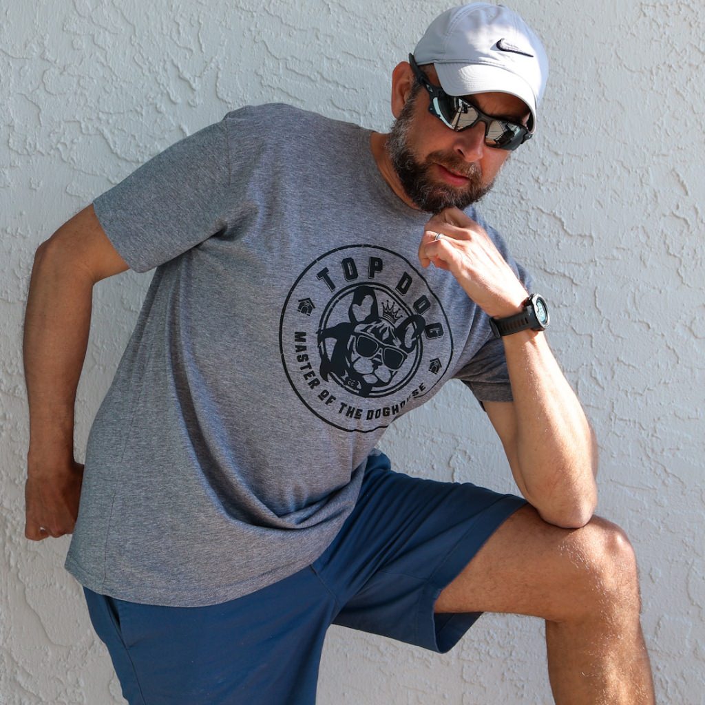 This image features a stylish unisex t-shirt, ideal for dog lovers, known as the "TOP DOG vintage tee." The tee is grey with a classic design that includes a prominent, circular black graphic on the front, depicting a cartoon dog with the text "TOP DOG - Master of the Doghouse.  unisex dog tshirt.  vintage soft tshirt.