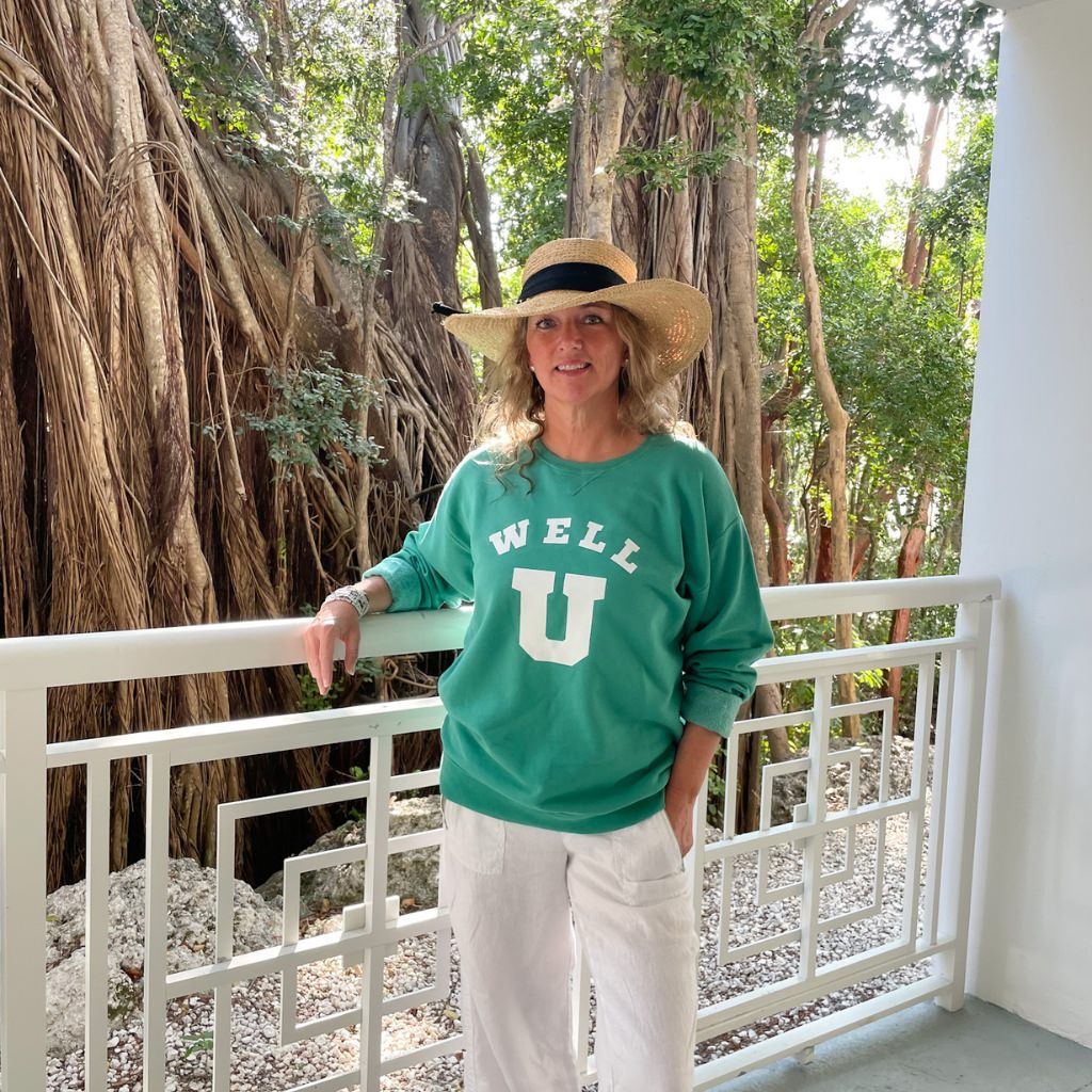 WELL U big white text on oversized green sweatshirt.  wellness apparel.  wellness journey intentional clothing.