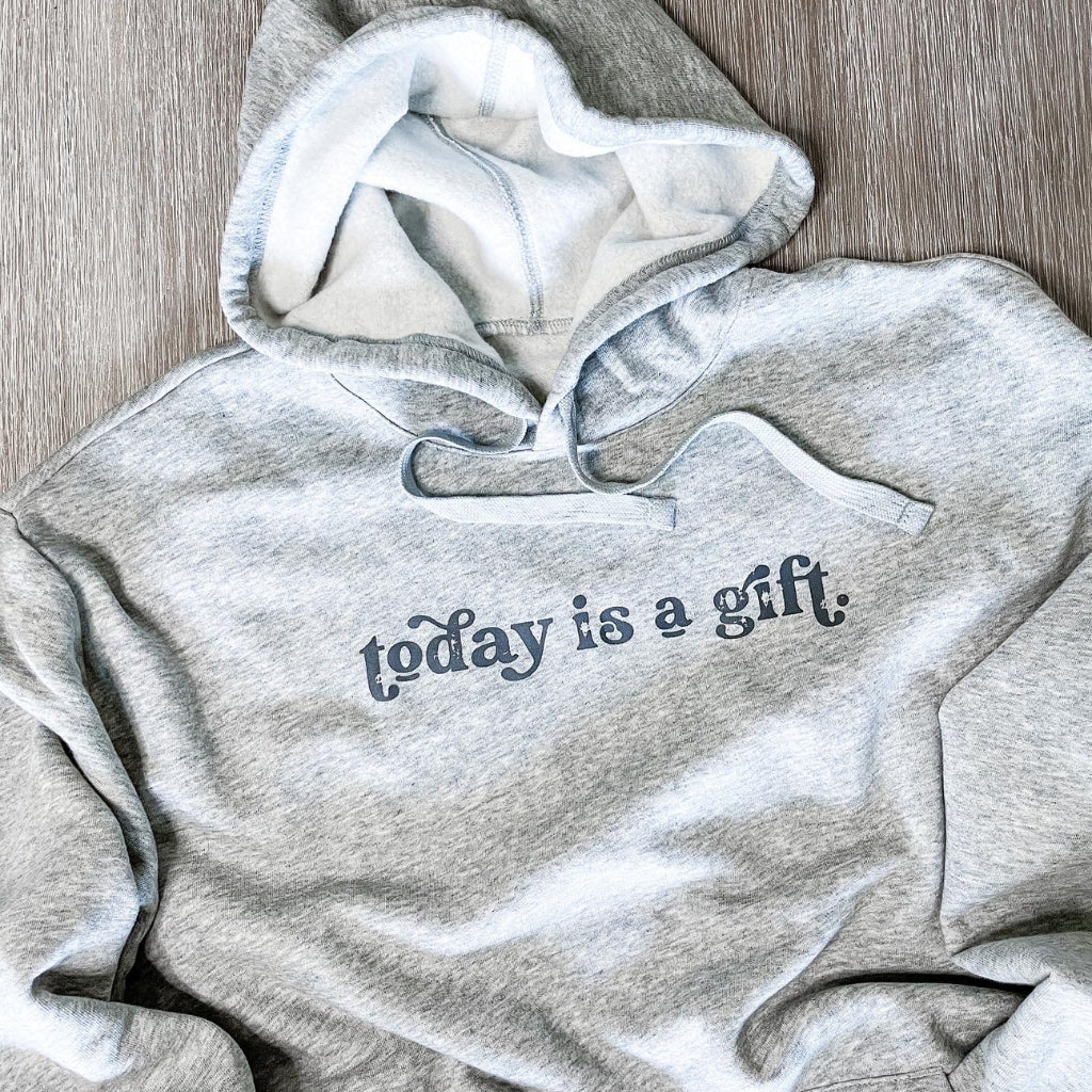 today is a gift, printed in charcoal gray ink on a heathered light gray hoodie.  unisex hoodie with screen printed image text saying today is a gift.