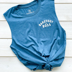 womens muscle tank top crew with fresh cut sleeves.  on the left chest BAREFOOT BOSS is printed in white text on the blue tank.  the waistline is showing how to tie knot the front of the tshirt.