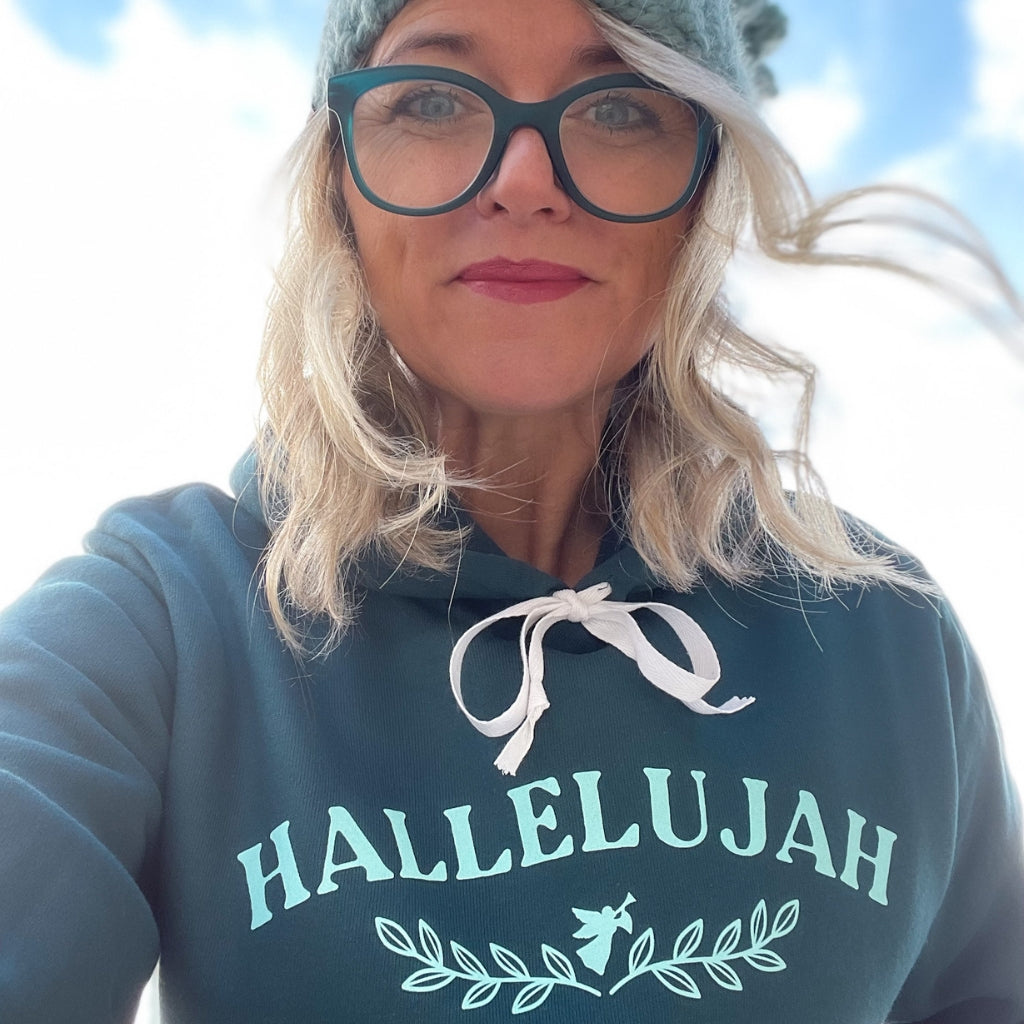 womens inspirational hoodie that says HALLELUJAH on the front with a small angel & vines under the word.  the word PEACE is on the sleeve.  super soft wellness hoodie in a deep turquoise color.  woman wearing a Hallelujah hoodie.