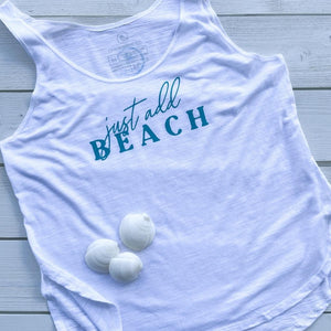 just add beach womens lightweight slub tank in white.  the words 'just add beach' on the front chest are a dark turquoise ink.  