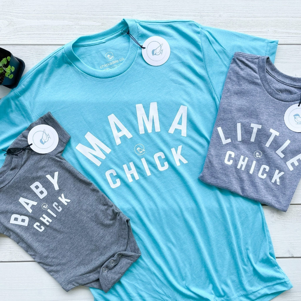 Mother & child matching tshirts.  MAMA CHICK is printed in white text on the front womens tshirt, LITTLE CHICK is printed on the childs tshirt and BABY CHICK is printed on the baby onesie.