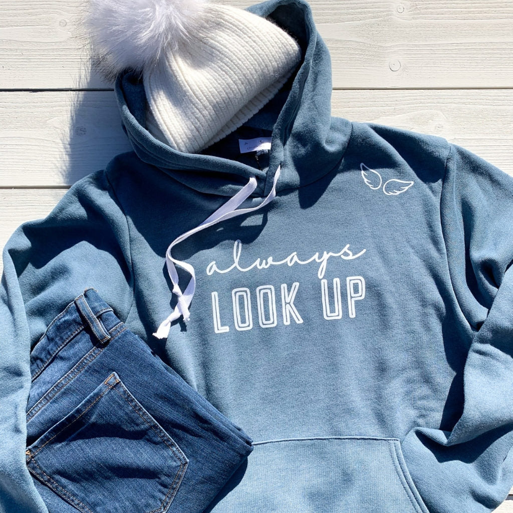 blue hooded sweatshirt for women.  super soft hooded sweatshirt in blue.  angel hooded sweatshirt.  screen printed inspirational hooded sweatshirt.  inspirational quotes on hoodies.  dusty blue hooded sweatshirt.  always look up hope sweatshirt.  warm fleece hooded sweatshirt.  womens hooded sweatshirt.  quote says 'always look up' with angel wings near the shoulder.